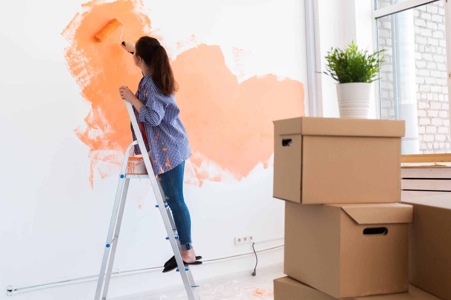 Our Services 3 cheerful woman painting the walls of new home ren 2021 12 09 07 27 07 utc